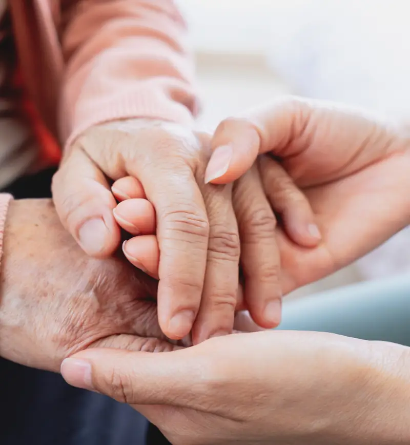 A caregiver and client sharing a warm, connected moment at home